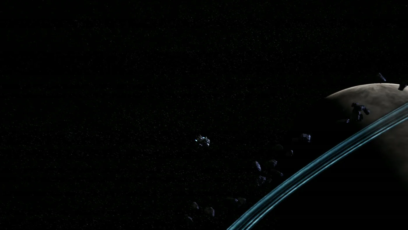 A ringed gas giant seen from an airless asteroid surface